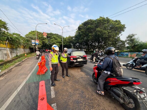 Sigap !! Personel Sat Lantas Polrestro Depok Bersihkan Tumpahan Oli Yang Bahayakan Pengguna Jalan
